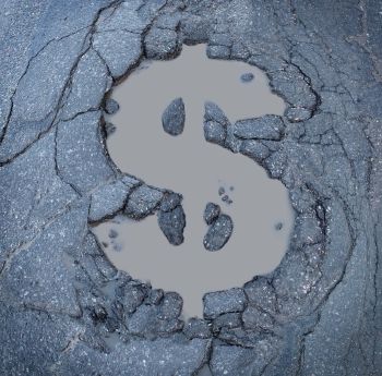 Asphalt damage in the shape of a dollar sign