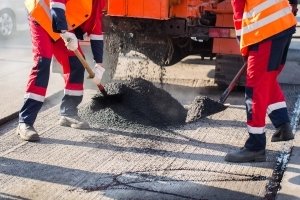 Contractors performing asphalt overlay